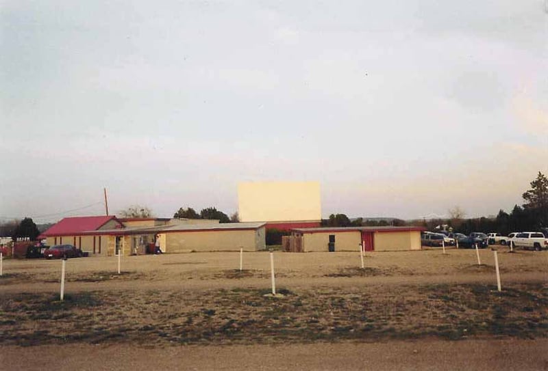the lot. The shared concession stand is on the left side of the picture, with the one screen cinema behind it. The building jutting out toward the left center part of the picture is the old video rental part of the complex, now closed. If you look closely