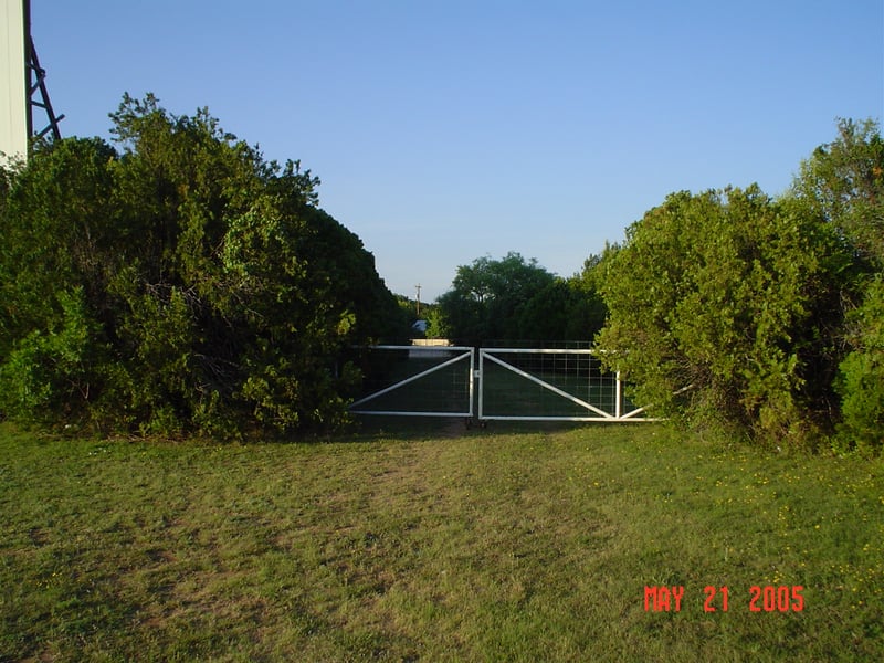 This is the old exit, now closed off. It's probably a good thing. With all of those bushes and trees in the way, traffic on the highway might not be able to see cars exiting. Cars now exit through the same driveway they came in on, which is not so obscure