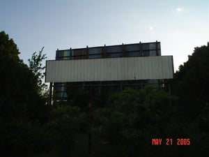 Here's an updated photo from one that I posted in 2002. This old sign no longer has the name "Town & Country" on it. That was the former name of this drive-in. The back of the screen is also shown.