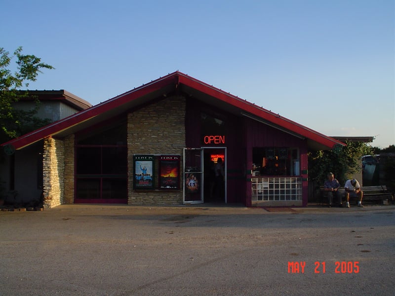 Here's the entrance to the indoor theater. The box office on the right is used for both the indoor theater and the drive-in. Owner Gene Palmer is sitting on the bench.