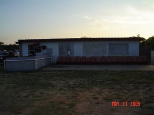 Here's a front view of the projection/restroom building, complete with outdoor seating. A speaker, located to the right of the projector, allows you to hear the movie.