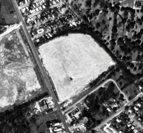 satellite photo; taken March 8, 1995; the lot to the right of the road