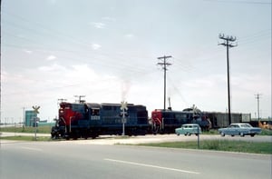Actually a photo of two Southern Pacific locomotives crossing 183 in 1966 but includes the Longhorn drive-in after it's move to 8800 Research area.