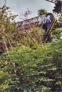 Upper portion of marquee with bicycle on top