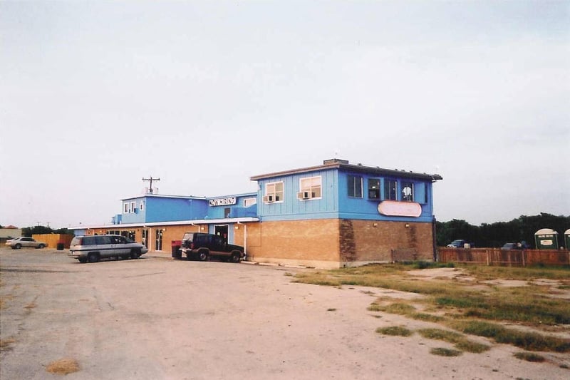 The concession/projection building shown in this photo has two upstairs projection rooms. The room for screens 1 and 2 is in the background and the room for screens 3 and 4 is in the foreground.