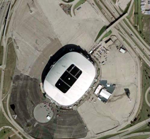 Aerial view of Texas Stadium present day.  The remaining screen is in the upper right corner of the lot, next to the freeway (Hwy 114). The building directly to the right of the stadium was used for projection and concessions.  There were two other screen