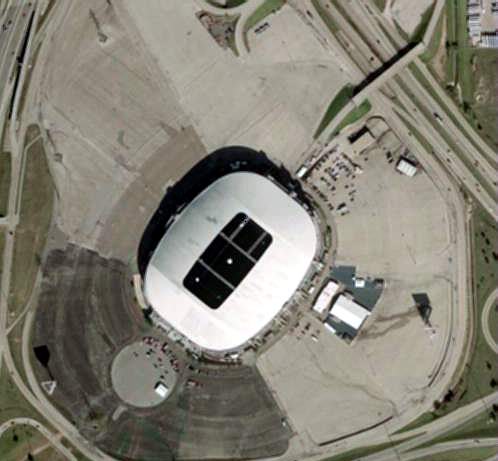 Aerial view of Texas Stadium present day. The remaining screen is in the upper right corner of the lot, next to the freeway (Hwy 114). The building directly to the right of the stadium was used for projection and concessions. There were two other screen