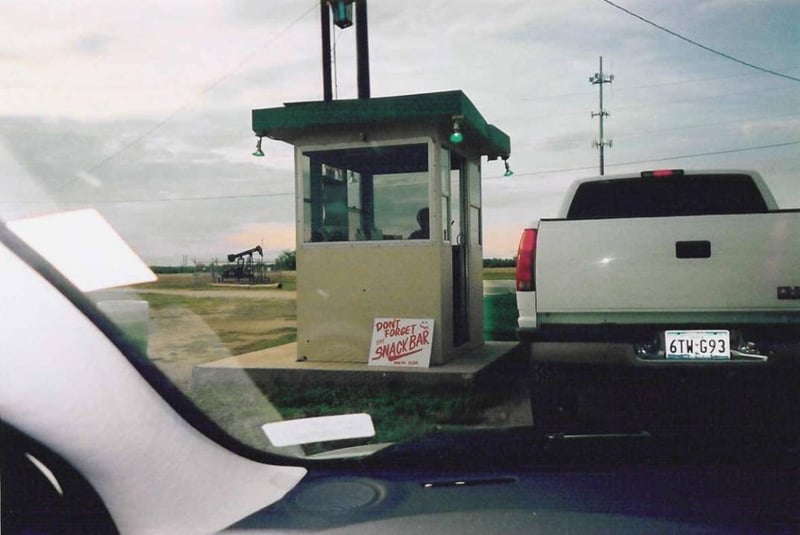 ticket booth with a pump jack in the background