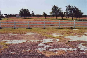 View from Hwy. 256. The concrete in front of the fence is probably a remain of the entrance and exit roads