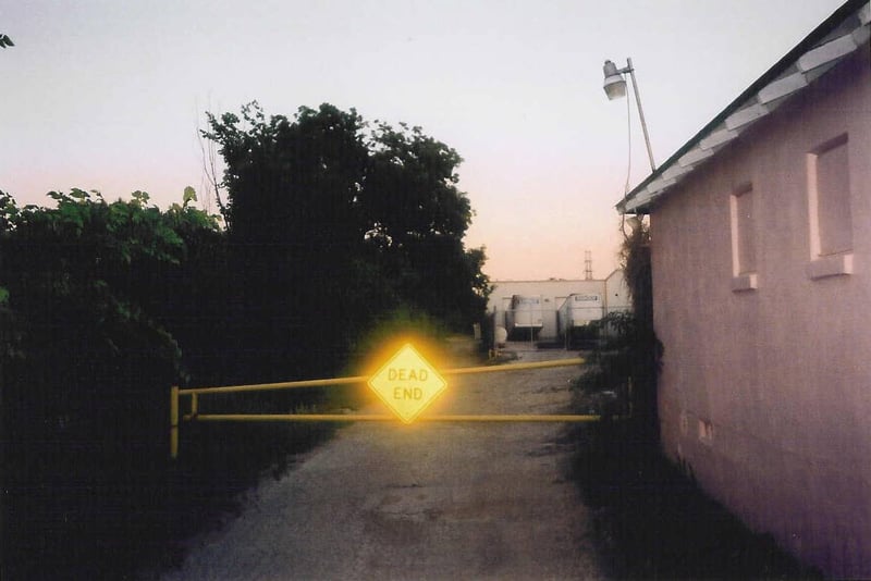 Here's the beginning of the path that runs along the side of the theater. It leads to the back screen. I was losing my daylight. Notice how the light from the flash bulb lit up the "Dead End" sign.