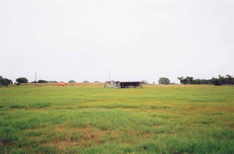 This is as close as I got. I couldn't bring myself to climb over the fence or to go to the house to ask them to show me around. The screen was probably located where the ditch is in the foreground. See the projection portholes?