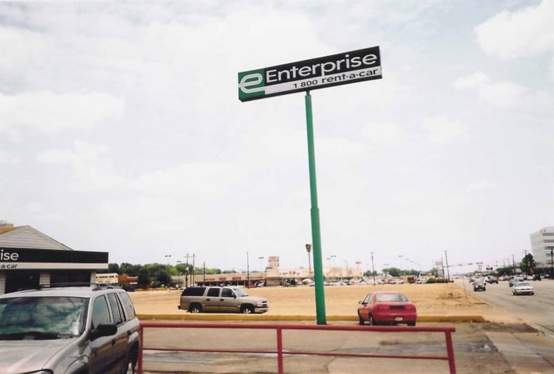 This is the same car rental place that is seen in the photo from 2002, but they have leveled all the buildings that were in back and to the right of it. This is approximately where the entrance to the old drive-in was.