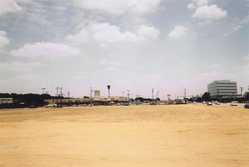 This area was just to the right of the Westview Drive-In. It might have originally been all green area. See the photo from 2002. Most of the stores in this space were closed before being torn down.