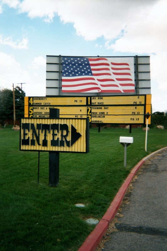Entrance with screen tower in background with American flag