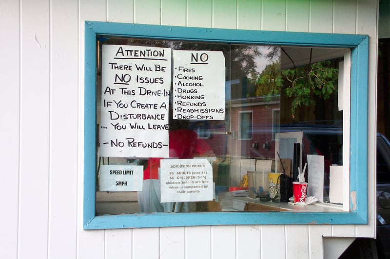 Signs posted on the box office glass.