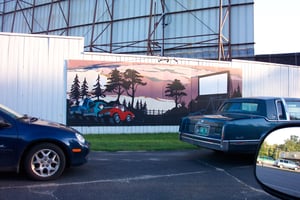 Mural on entrance road fence.