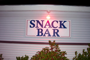 Snack bar sign after dark.