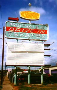 Marquee sign for theater.  The word "Indoor" is in neon only superimposed over the painted and neon "Drive-In"  Also long gone is the U. S. Highway 410 designation anywhere within miles of this city.