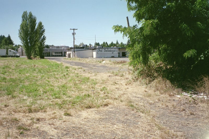 Standing on the edge of the field behind the ticket booth. Fat Tuesdays closed 12/31/04 and will be torn down for new development.