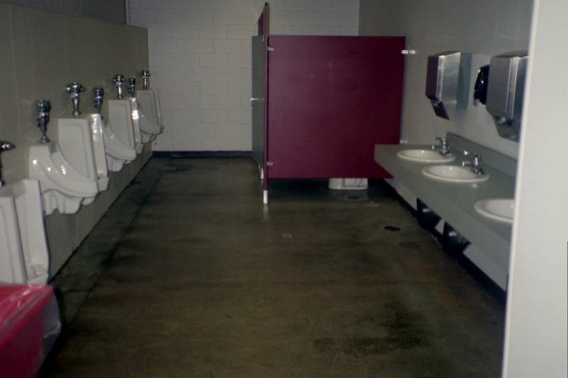 the men's room with new countertop. 8 urinals and 3 stalls. Looks like they had 5 stalls at one time. Cramped maybe, but hardly nasty.