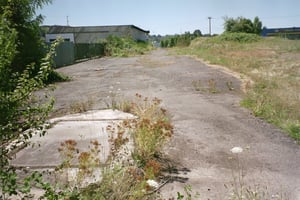 Looking from the ticket booth towards the entrance. The screen tower would be on the right where the blackberry bushes are.