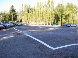 Park & Ride cars parked along the same raised rows as cars in the drive-in.