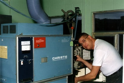 Projectionist Ken Layton threads up for yet another showing of Titanic.