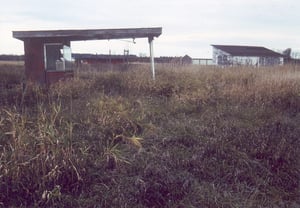 This picture shows the ticket booth and the projection/concession building in the distance. The screen tower was standing behind the building to the right with the slanted roof