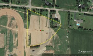 aerial view with former site outlined-now parking lot for racetrack