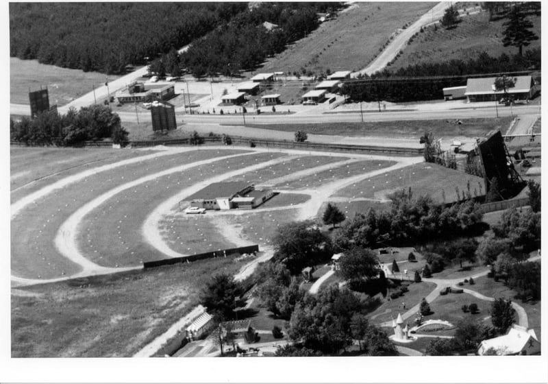 aerial photo of field, building, and screen tower