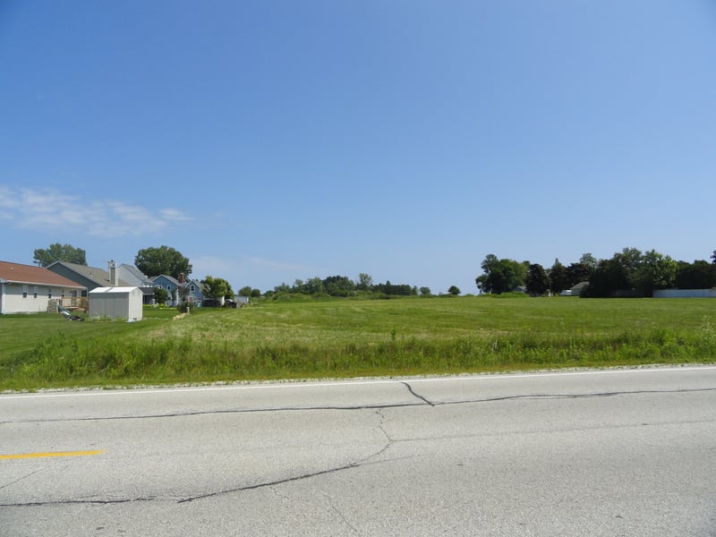 now an empty field surrounded by housing