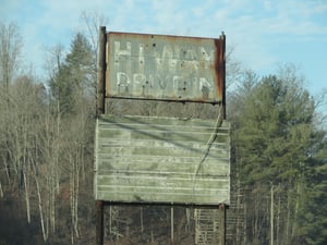Faded sign with screen remnants in the background-HiWay Drive-In