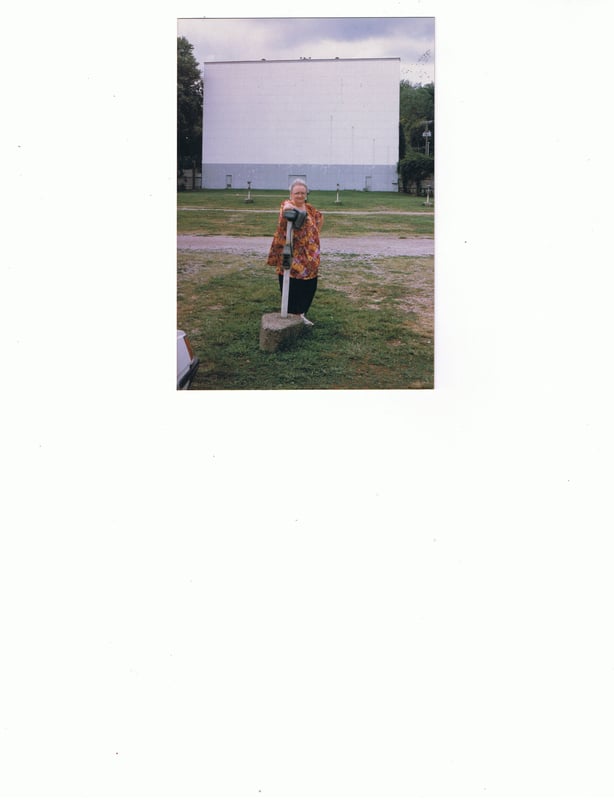 My mother Nancy Foster posing in front of Drive Inn screen