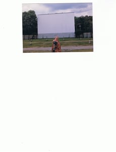 My mother Nancy Foster posing in front of Drive Inn screen