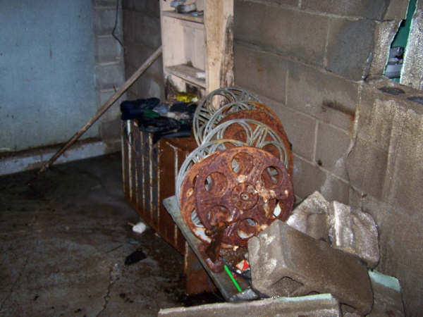 Here you see the Film Reels and cabinet. The building is in poor condition and part of the wall has collapsed on the table.