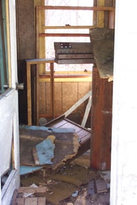 Through the open doorway of the ticket booth.