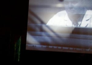 The soundtrack is projected onto the trees behind the screen.