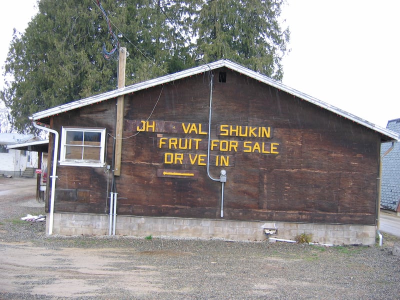Signage on highway fruit stand points the way to the drive-in.