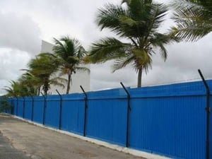 Side view of screen.  Palm trees line the fence around the drive-in. Very scenic. The road going into the drive-in is very long and the entrance to the theatre is in the back.