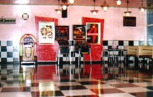 The diner is fitted with booths so you can enjoy a hamburger, steak, popcorn or coke. Grease has always been a drive-in favorite, the last time it ran at Coburg fireworks burst from above the screen as the end credits rolled! Anna Joske Photo 2001.