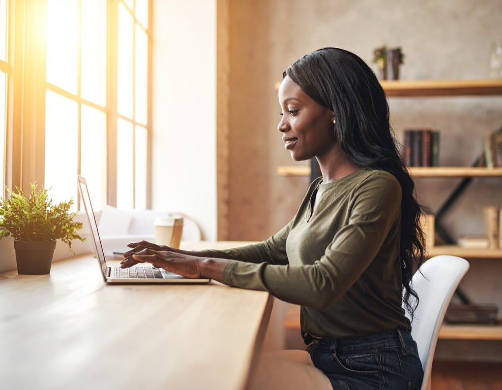A woman journaling in a warm, sunlit room — finding clarity through reflection