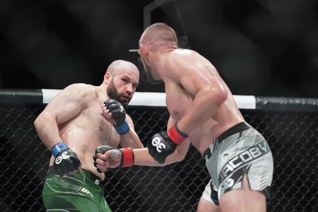 Azamat Murzakanov evading Dustin Jacoby. Credits to: Denny Medley - USA TODAY Sports.