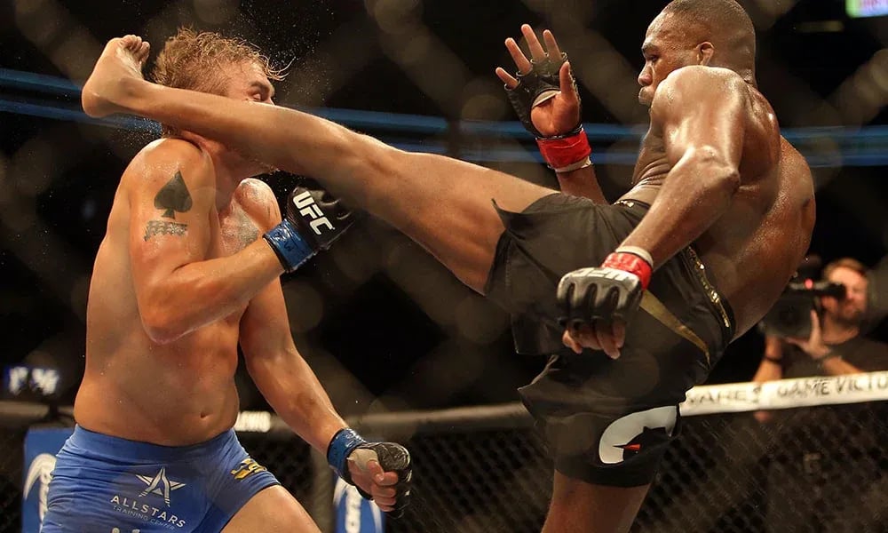 Jon Jones head kicks Alexander Gustafsson in their first fight. Photo by MMAJunkie.