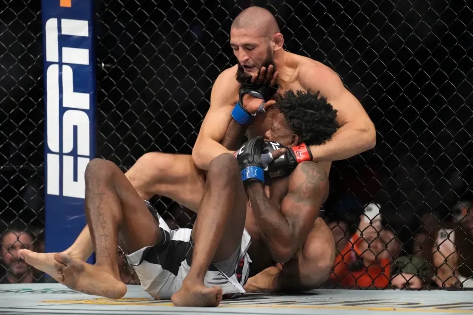 Khamzat Chimaev quickly finishes Kevin Holland. Photo by John Locher, AP Photo.