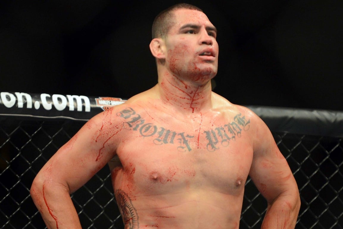 Cain Velasquez looks over at his opponent Antonio Silva in between rounds at UFC 146. Credits to: Ron Chenoy-USA TODAY Sports