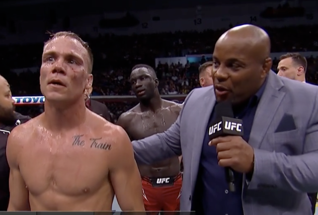 Landwehr speaking to Daniel Cormier after beating David Onama. Photo by Yahoo Sports.