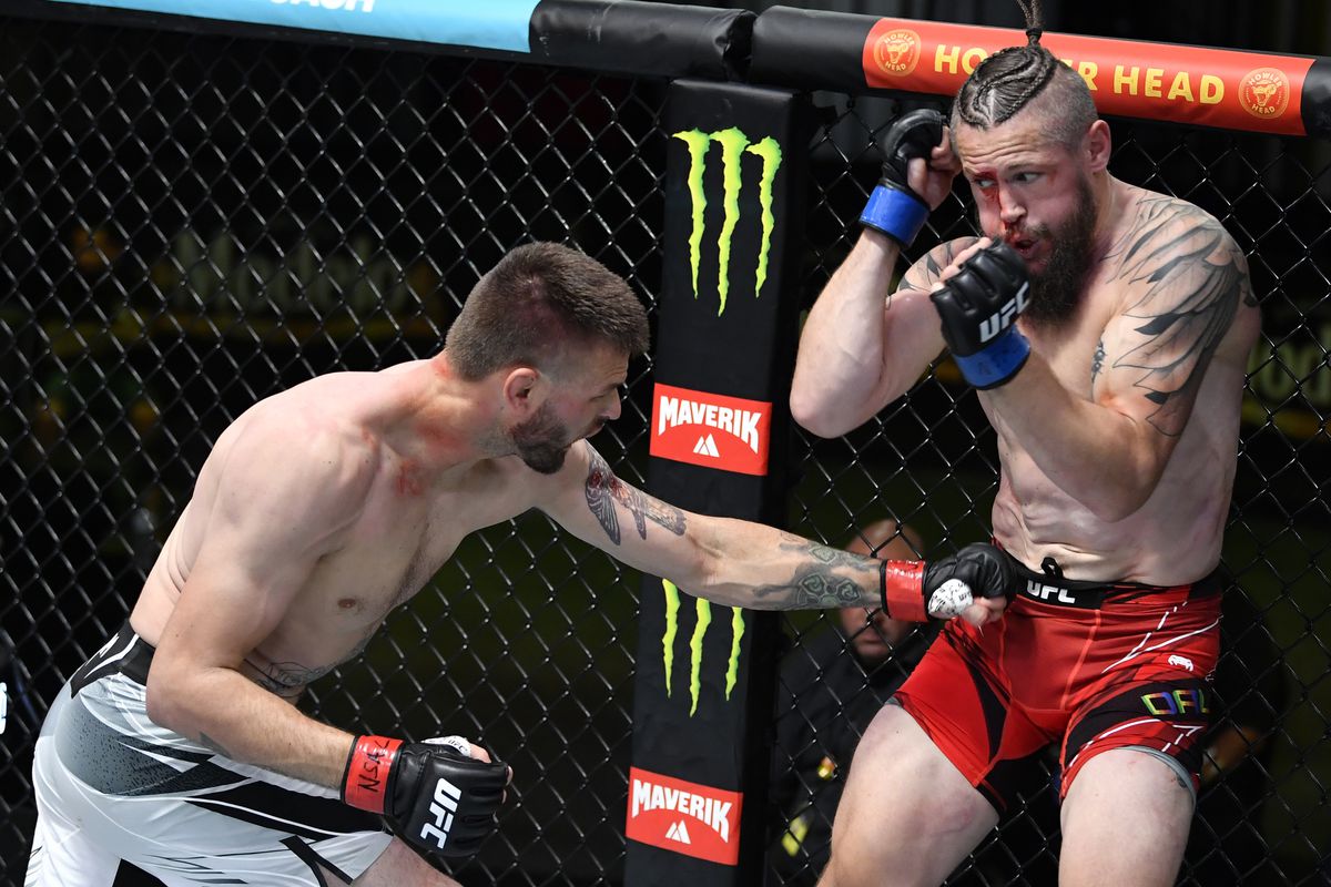 Tim Means blasts Nicolas Dalby with a body shot. Credit: MMA Fighting.