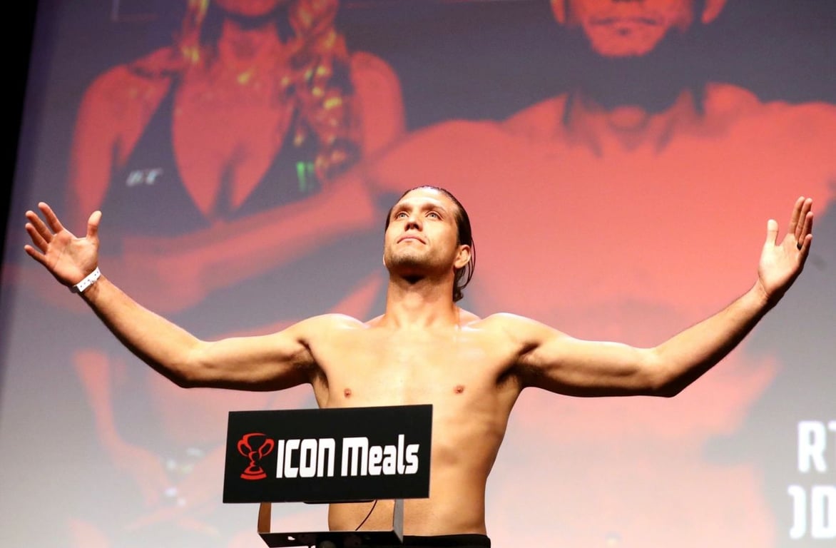 Brian Ortega remains calm on the scales ahead of his main event fight. Credits to: AP Photo/Gregory Payan