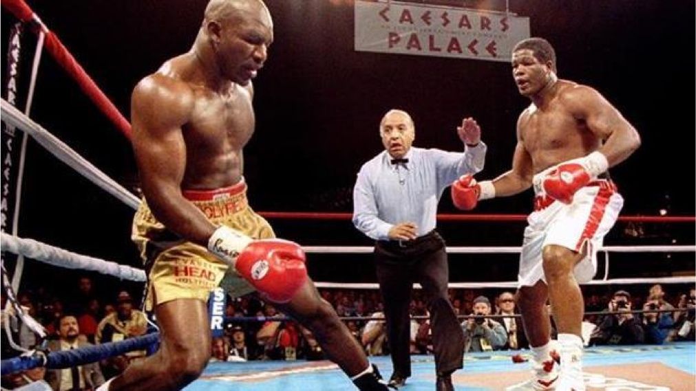 Evander Holyfield falling to the canvas after being stunned by Riddick Bowe. Credits to: AP Photo