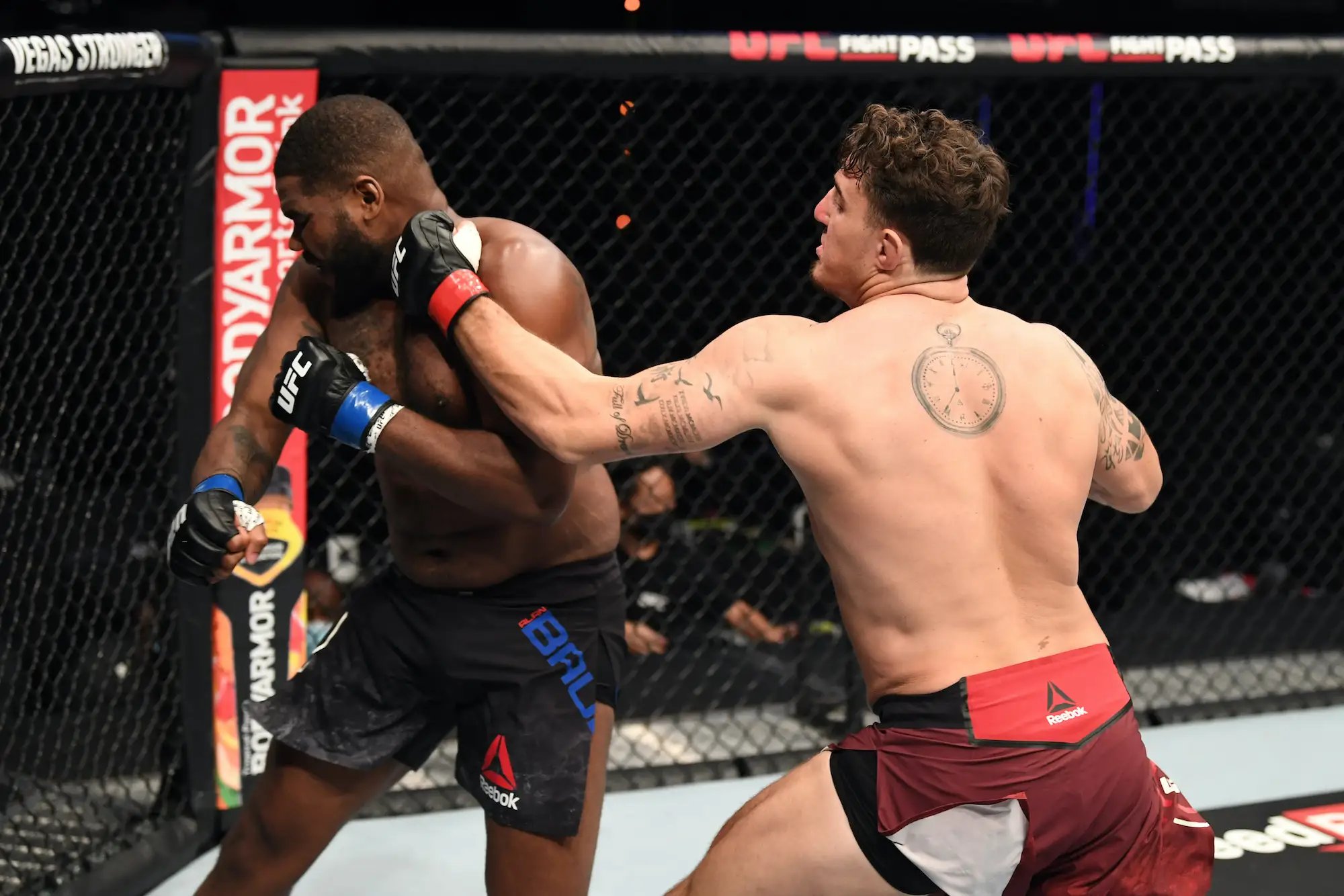 Tom Aspinall lands the left hook on Alan Baudot. Credit:  Josh Hedges/Zuffa LLC.
